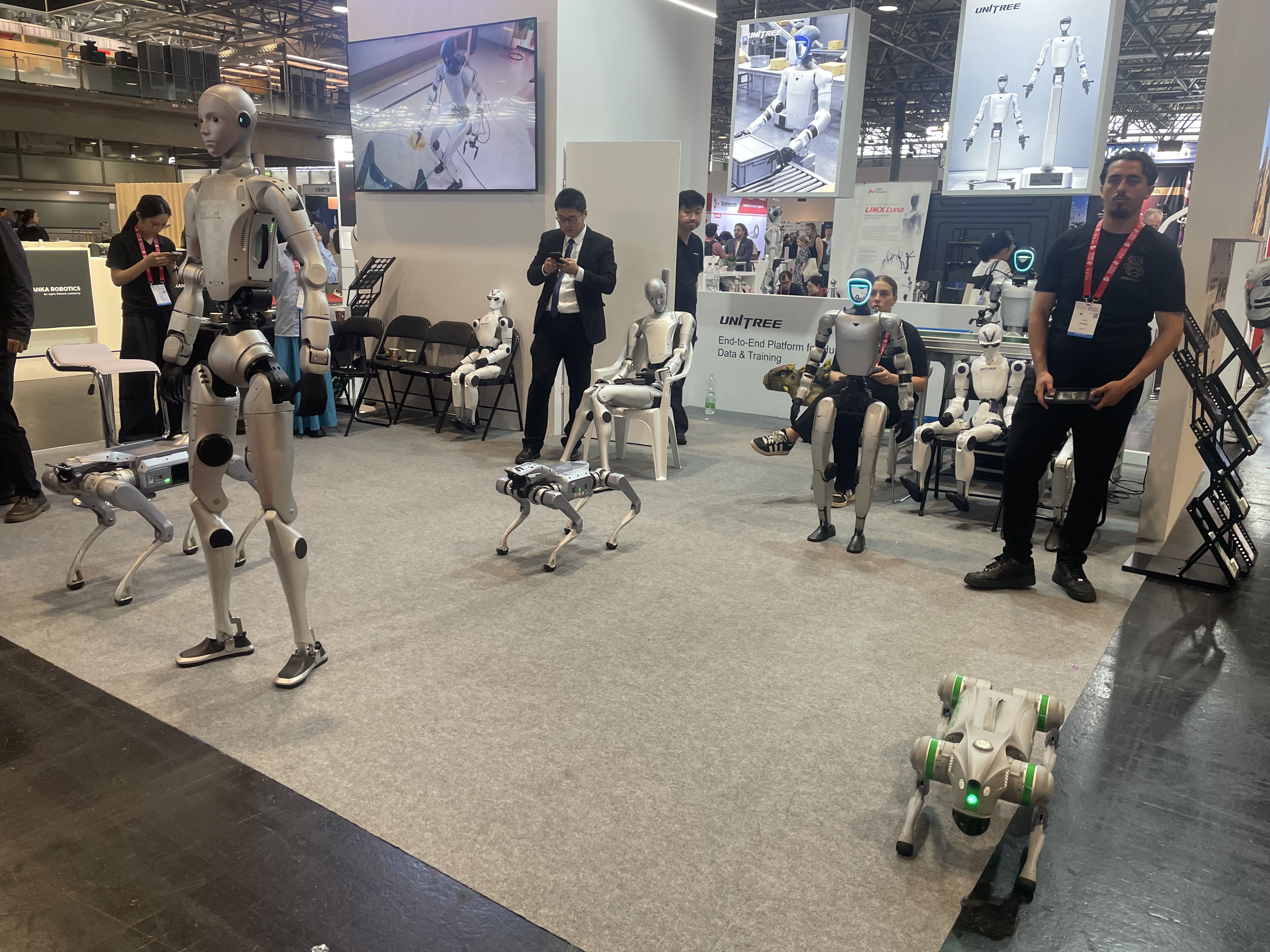 Humanoid and quadruped robots demonstrating together at the ICRA exhibition